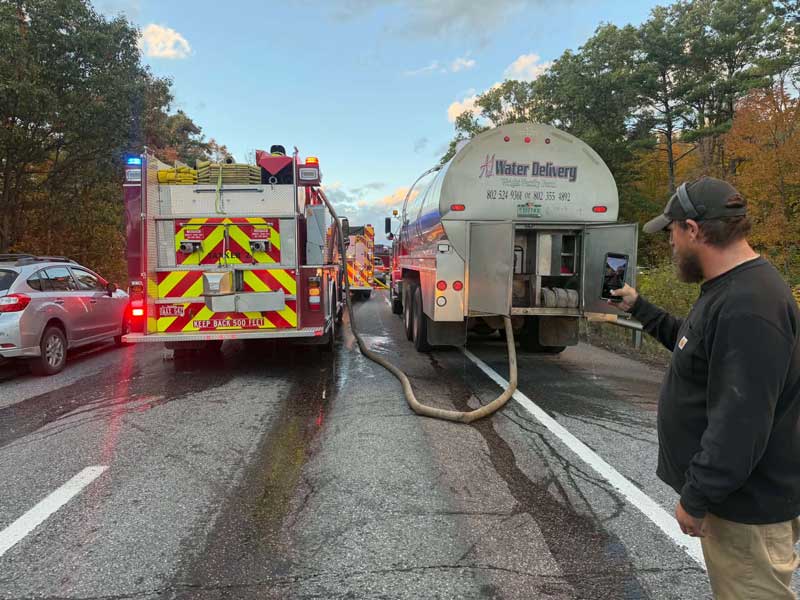 A1 Water Delivery Truck Assisting a Firetruck in Need of Water